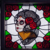 Vibrantly colored stained glass artwork depicting 'La Muerte,' showcasing intricate details and profound symbolism.